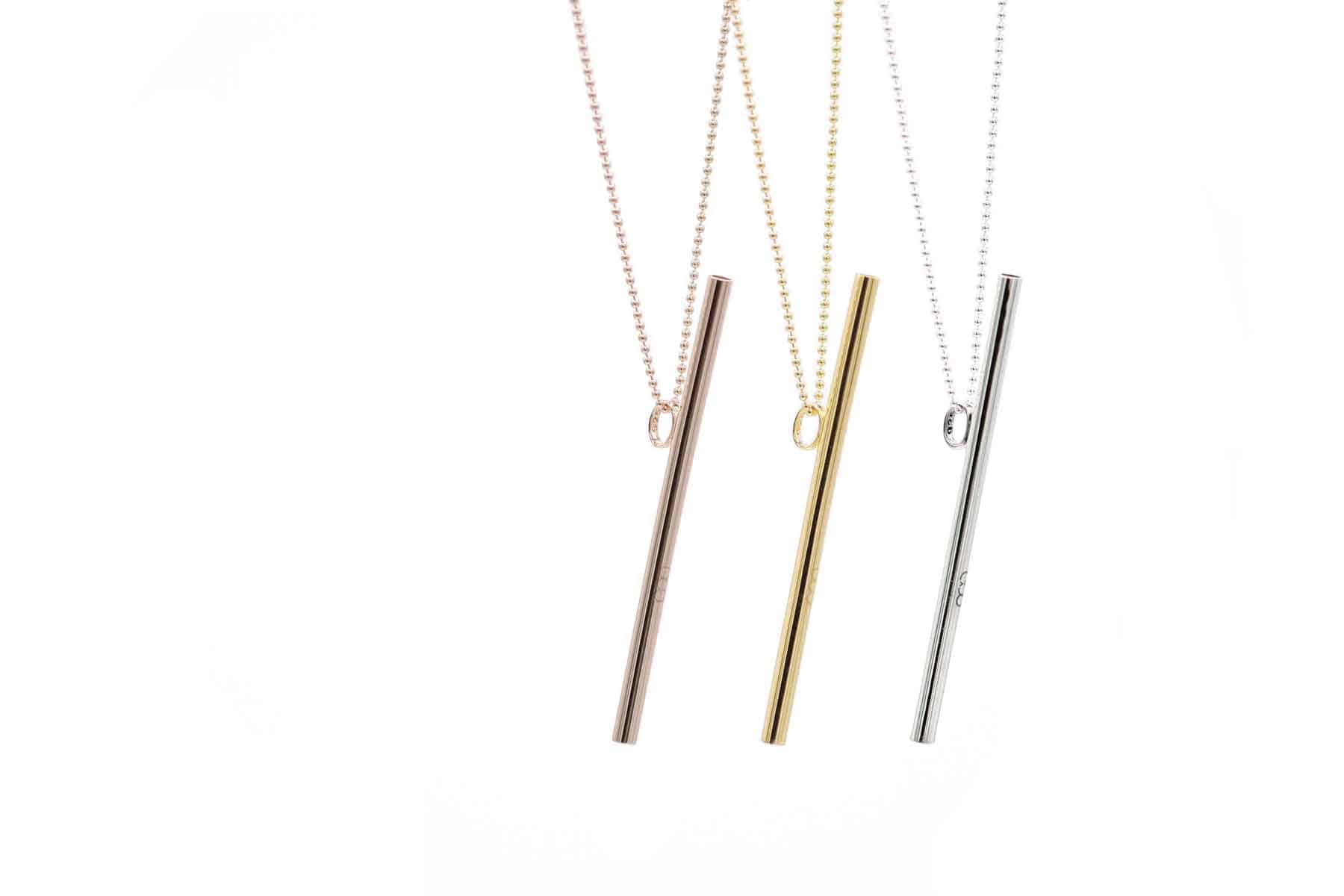 Three OOVO Vocal Straw Necklaces in sterling silver, gold vermeil, and rose gold vermeil, hanging on chains